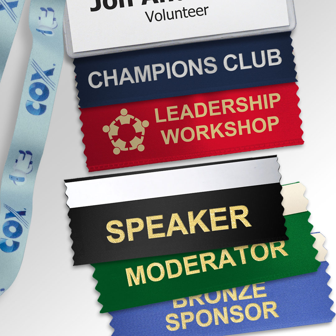 Various badge ribbons shown with a badge holder and lanyard.