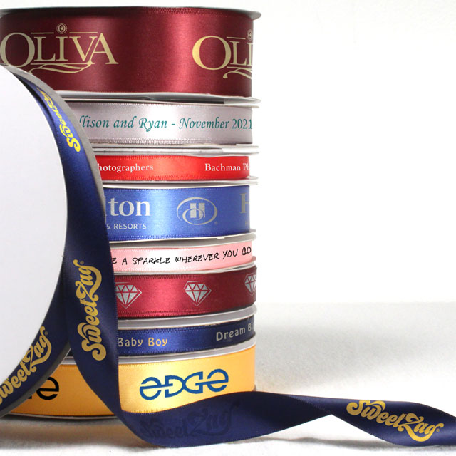 A stack showing continuous print single face satin ribbon rolls.