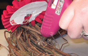 finish the wreath by gluing the rosettes down with hot glue