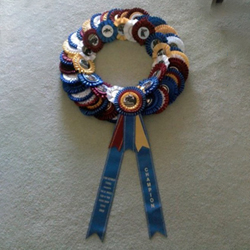 A wreath made from dozens of cut rosettes and a few short and two long streamers.