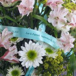 tropic blue single face satin ribbon imprint metallic ivy green with daisies and other flowers