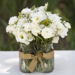 flowers in clustered mason jars, held together with a ribbon