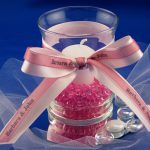 organza and satin ribbon rolls tied around a candle holder for a wedding