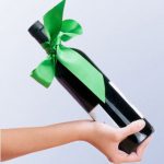 unique holiday crafts and wrapping with personalized ribbons wrapped around a bottle