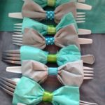 strips of ribbon roll wrapped around cutlery create a bow tie to celebrate your dad