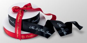 two ribbon rolls designed with bride and groom names for weddings