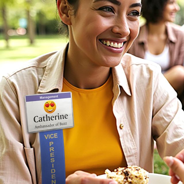A woman wearing a badge ribbon attached to a badge holder that has a printed insert with a fun, festive title.